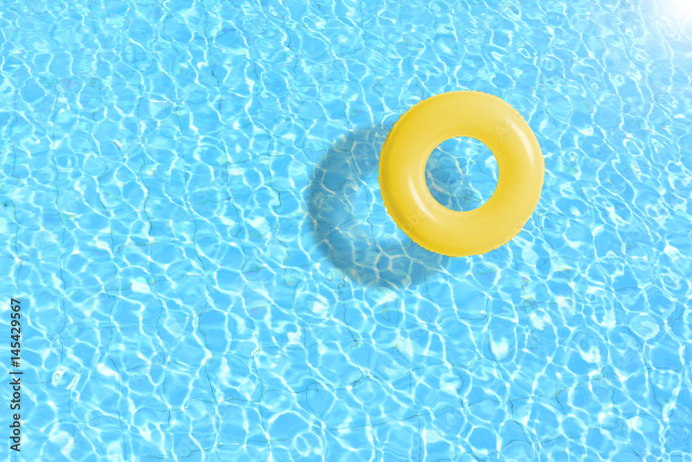 Clear pool water with yellow inflatable tube