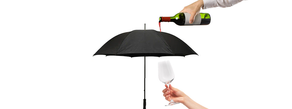 Umbrella covering bottle of wine pouring into glass